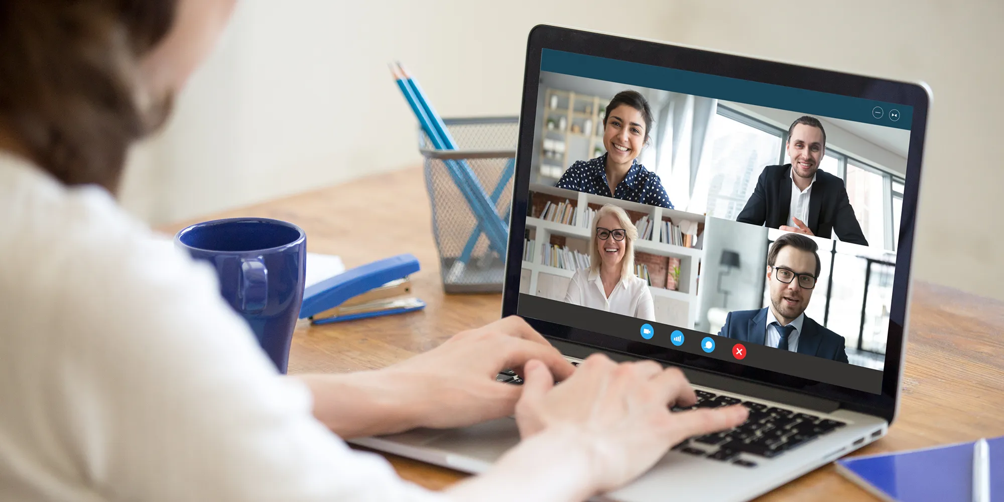 Frau sitzt vor Laptop mit Videomeeting